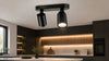 Modern black ceiling track light with two adjustable spotlights in a contemporary kitchen setting.