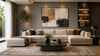 Modern living room with a large beige sectional sofa, abstract art on a gray wall, potted plant, and a sleek coffee table; features soft, ambient lighting.
