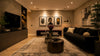 A stylish living room showcasing black sofas and a television, creating a contemporary atmosphere.